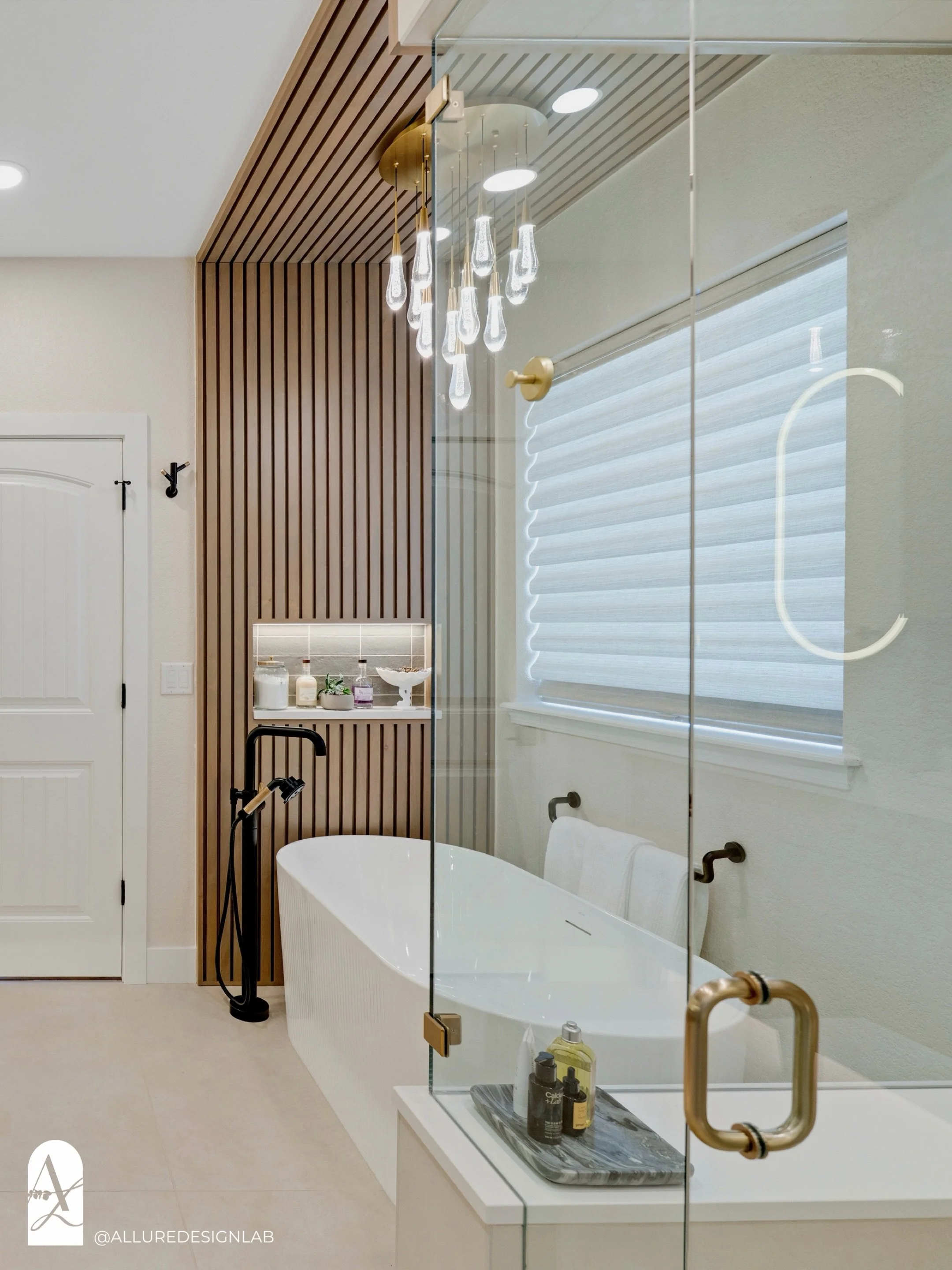 Designed around the ritual of slowing down.

This primary suite pairs a sculptural soaking tub, layered lighting, natural materials, and a steam shower that feels like a retreat of its own. Heated floors bring warmth underfoot that adds another layer