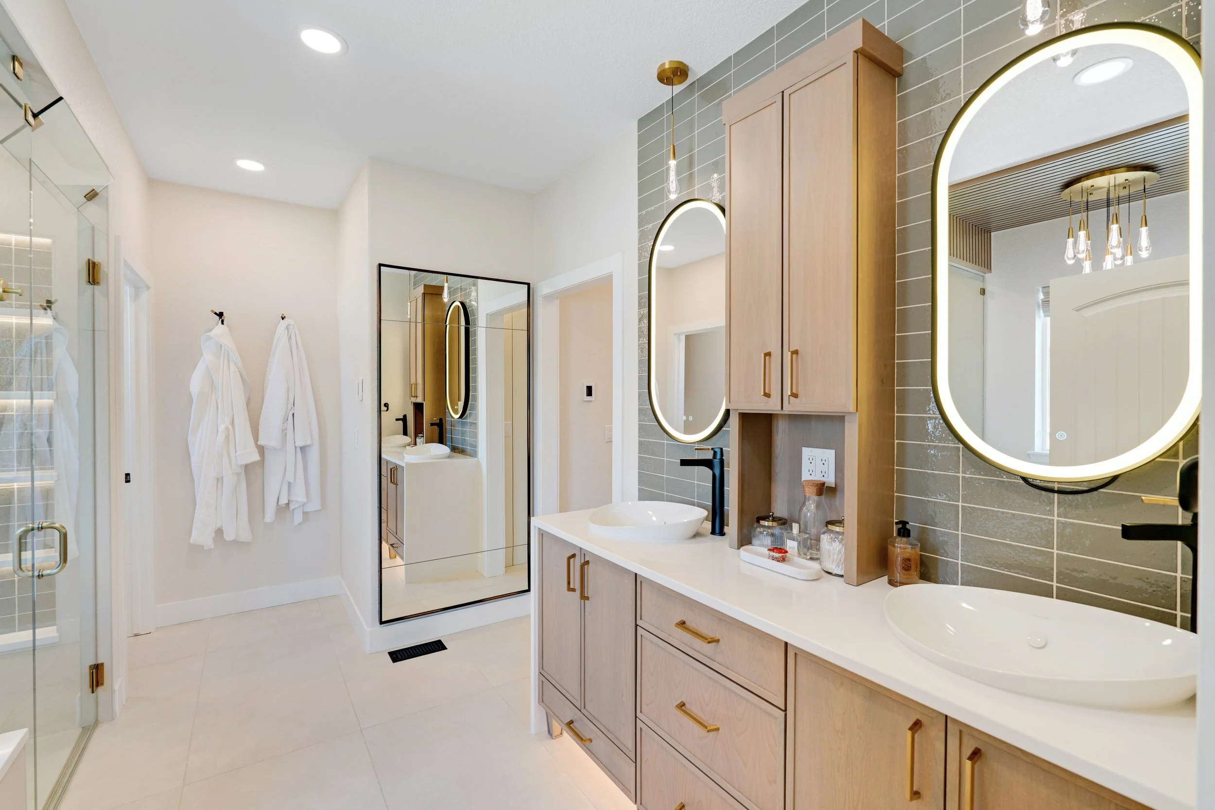 PRIMARY BATHROOM, MAPLE CABINETS, DECORATIVE FIXTURES, TILE WAINSCOT, LIT MIRRORS