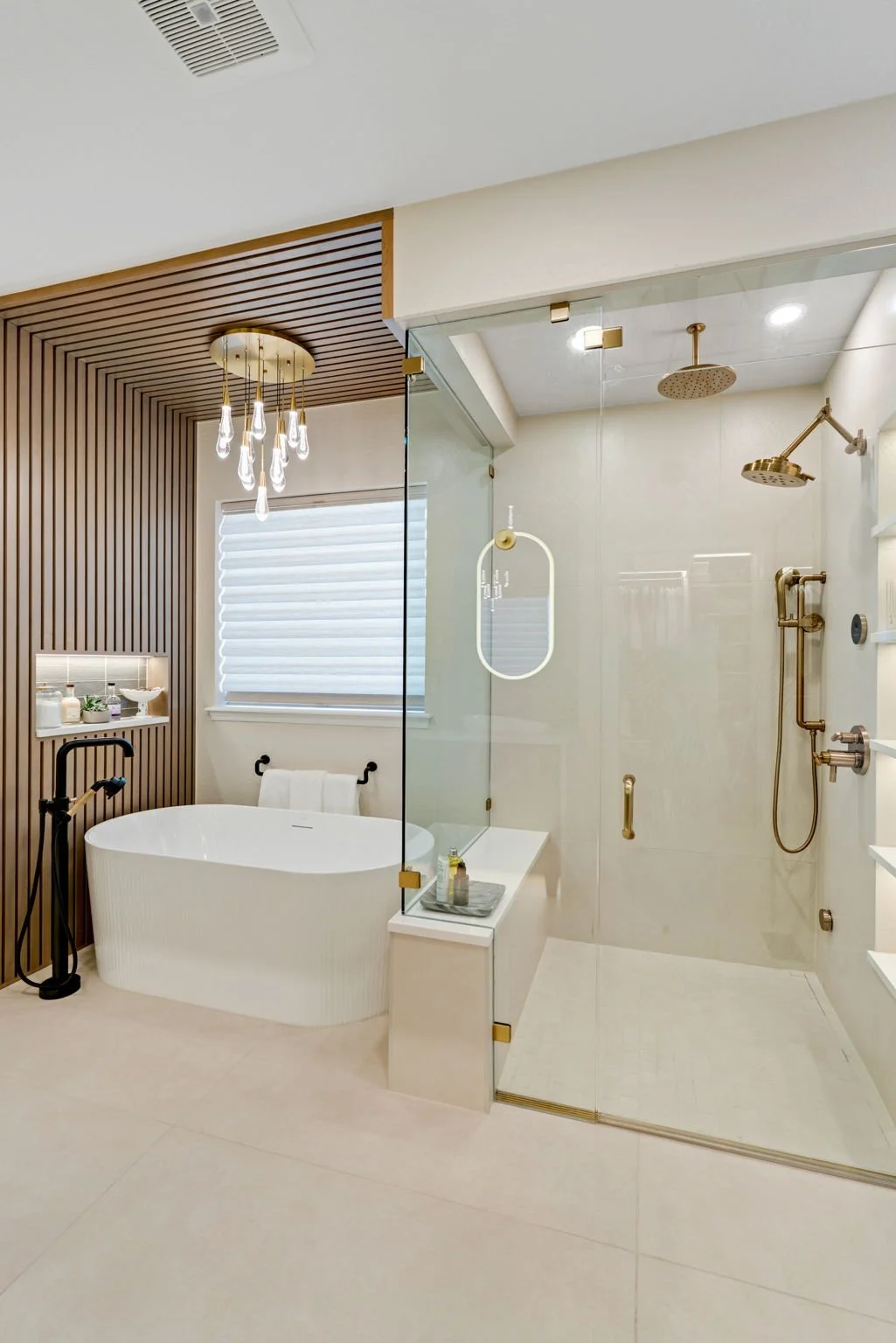 PRIMARY BATHROOM, SLATTED WALL, FREESTANDING BATHTUB, DECORATIVE LIGHT FIXTURES