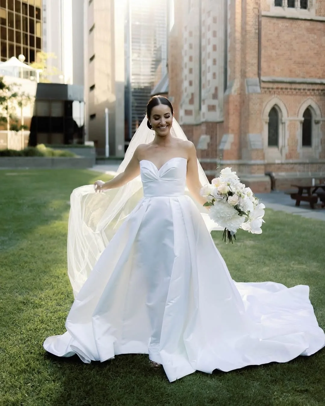 Nicole looked breathtaking in this modern classic gown crafted from luxurious silk Duchesse satin ✨ 
Featuring a sculpted, bias-moulded petal neckline and a timeless 1950s silhouette, the design exudes elegance and sophistication 🤍 
The cathedral-