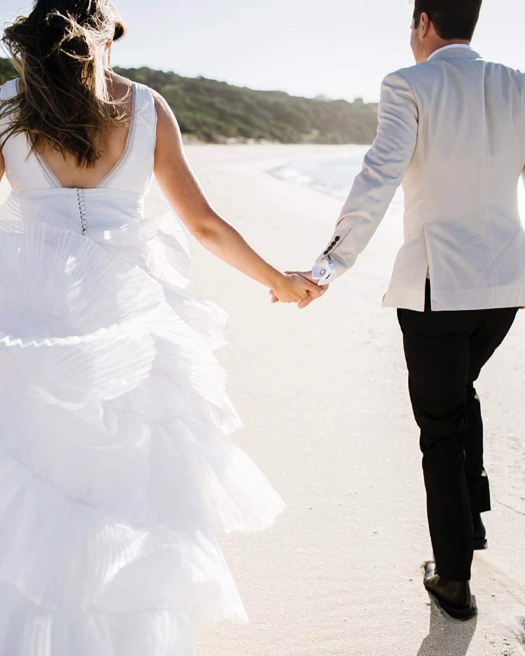 Aimee&rsquo;s bespoke gown was handcrafted in natural silk organza, featuring individually pleated, graduated layers that created a soft silhouette 🤍
The design was completed with a dramatic deep V neckline and backline, blending elegance with moder