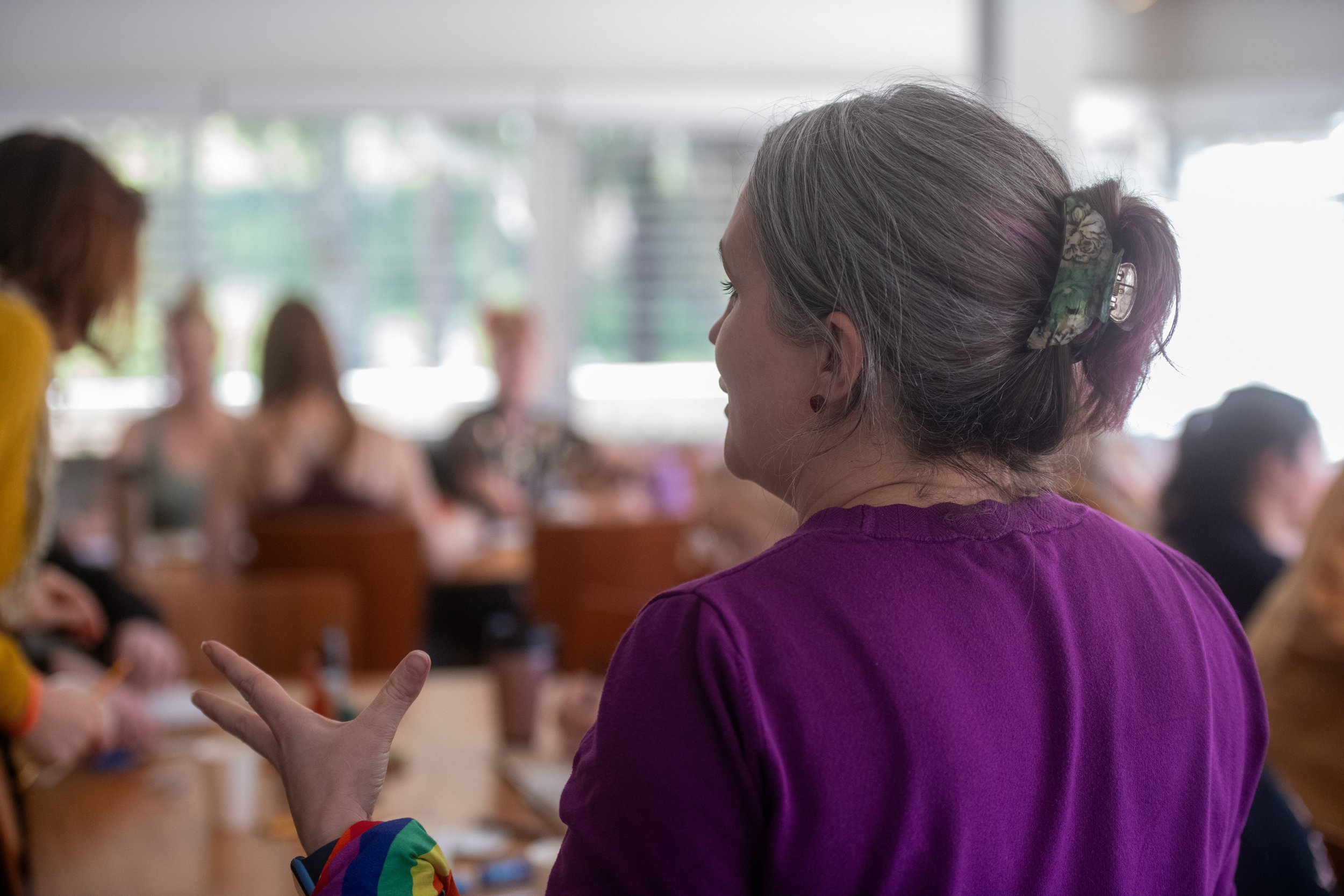 Facilitator speaking to a group during a workshop.