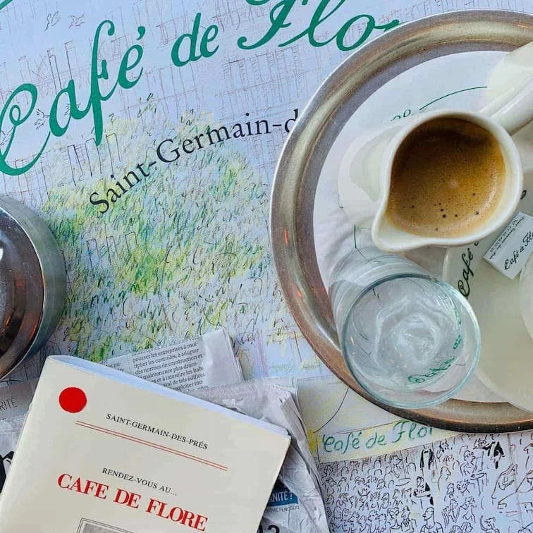 coffee and book on paris cafe table