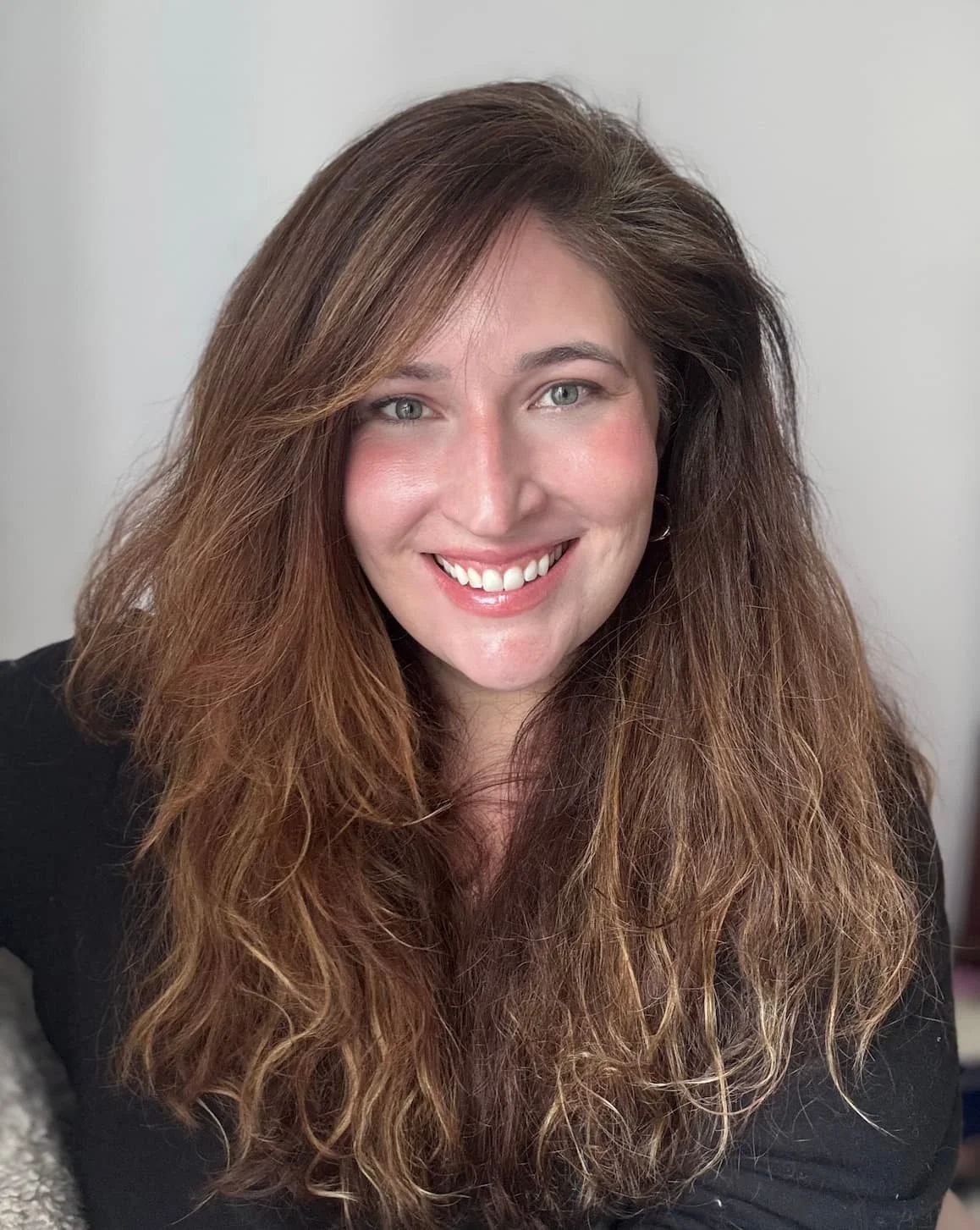 Therapist with long brown hair smiling warmly