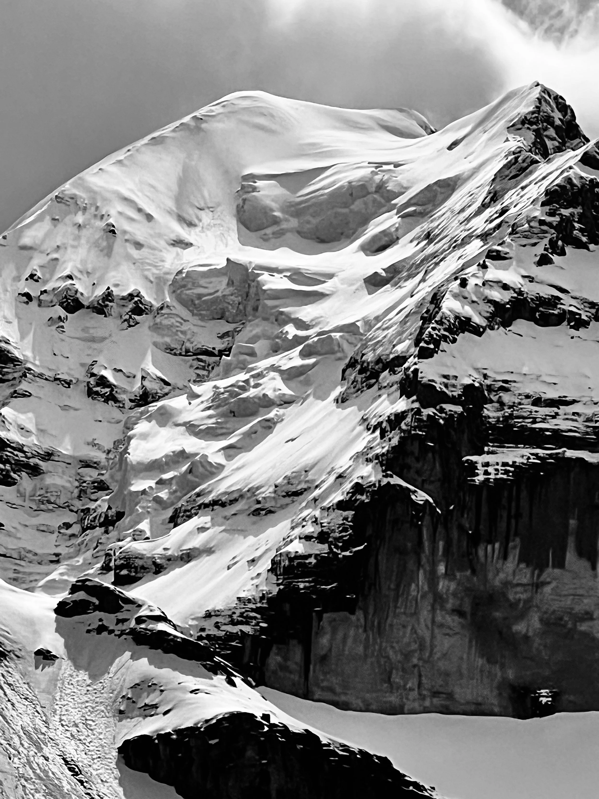 Schneekuppen, Gletscher und Felsflanken in Schwarzweiss.