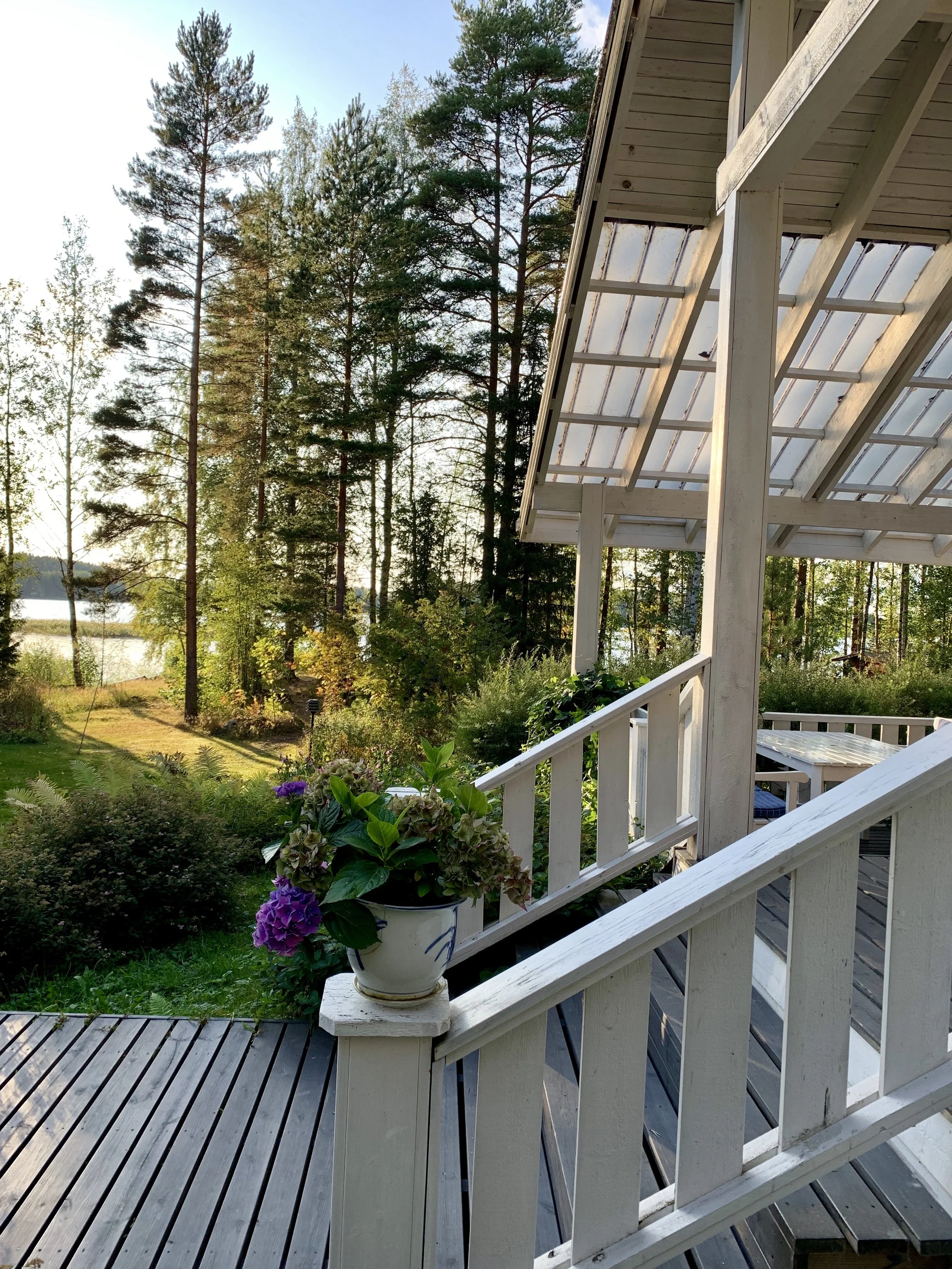 View from the porch at Blueberry Villa overlooking the garden and Lake Saimaa, a calm setting for Finnish Happiness Camp wellbeing days.