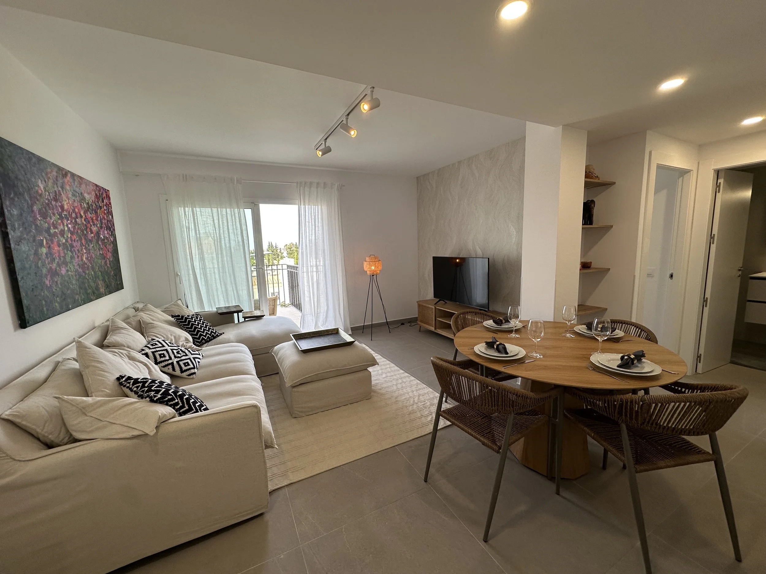 There Panorama Penthouse living and dining room connects to the open kitchen.