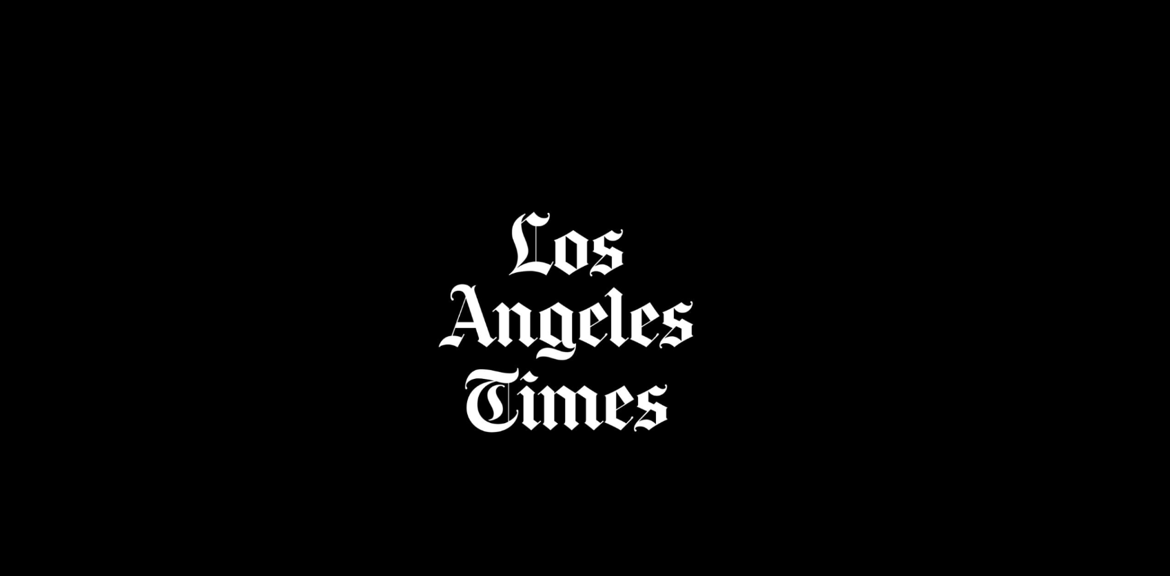 Los Angeles Times logo in blackletter font on a black background.