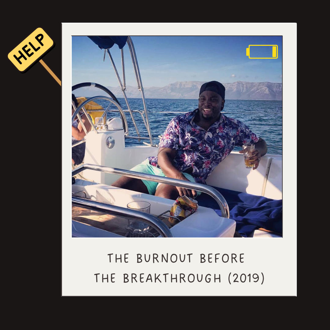 A smiling man on a boat holding a drink, wearing a patriotic floral shirt, with water and mountains in the background, captioned "The burnout before the breakthrough (2019)."