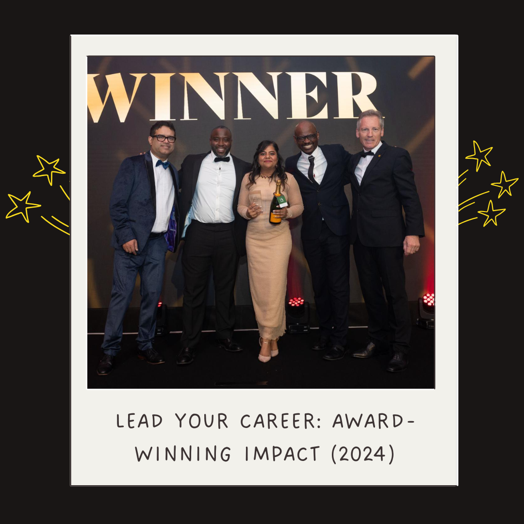Group of five people in formal attire posing with a woman holding a champagne bottle and a glass, standing in front of a large screen displaying the word 'WINNER'. The event appears to be an awards ceremony in 2024.
