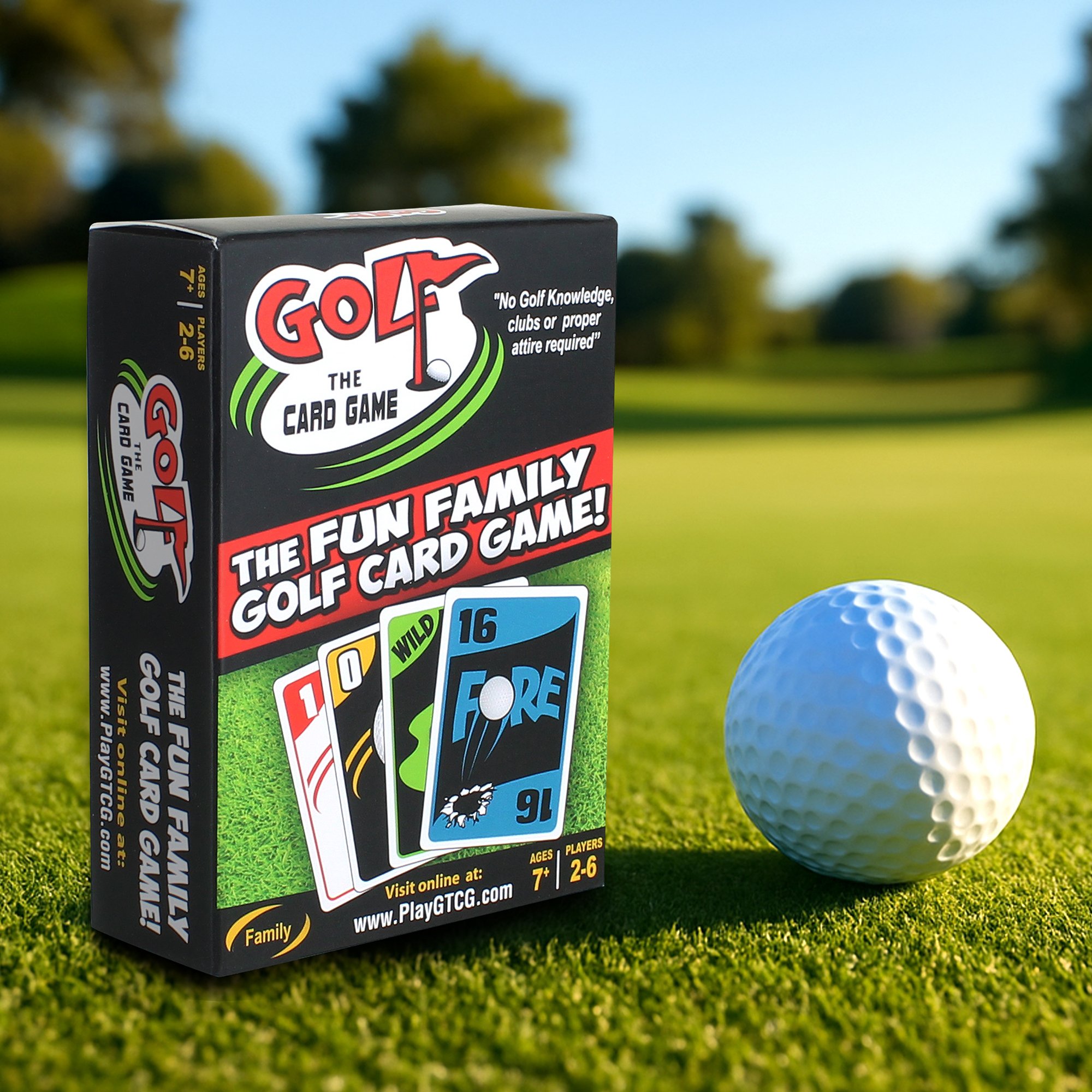 A box of Golf the card game and a golf ball on a golf course.