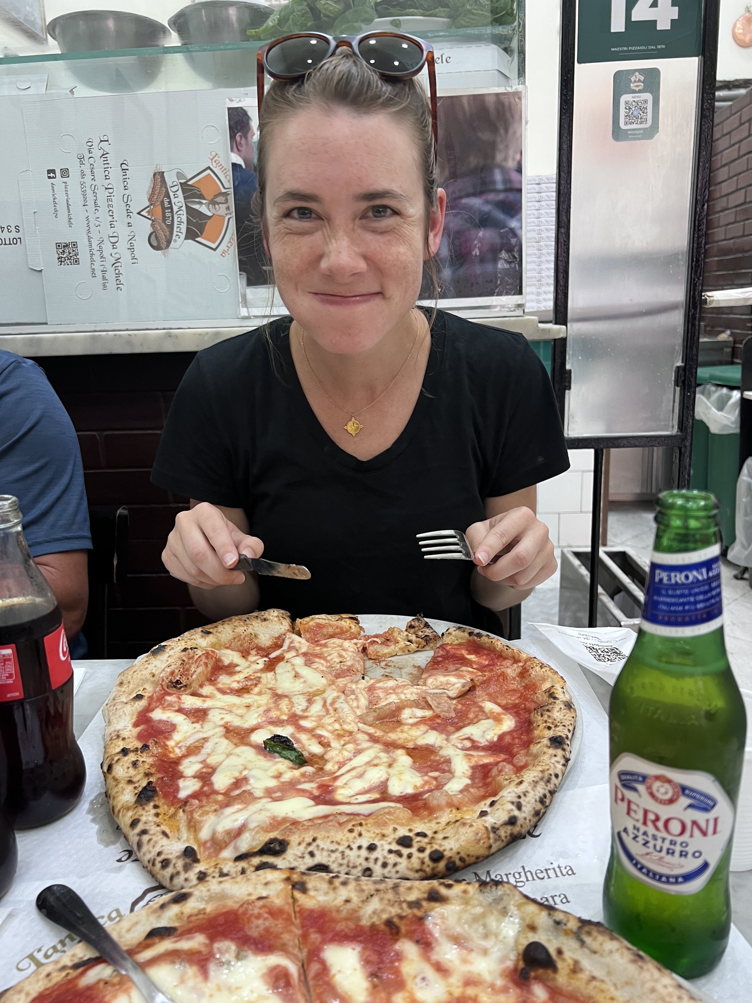 Eating pizza at the famous L'Antica Pizzeria da Michele and then in Napoli, Italy and chasing it down with a Tums to avoid heartburn.