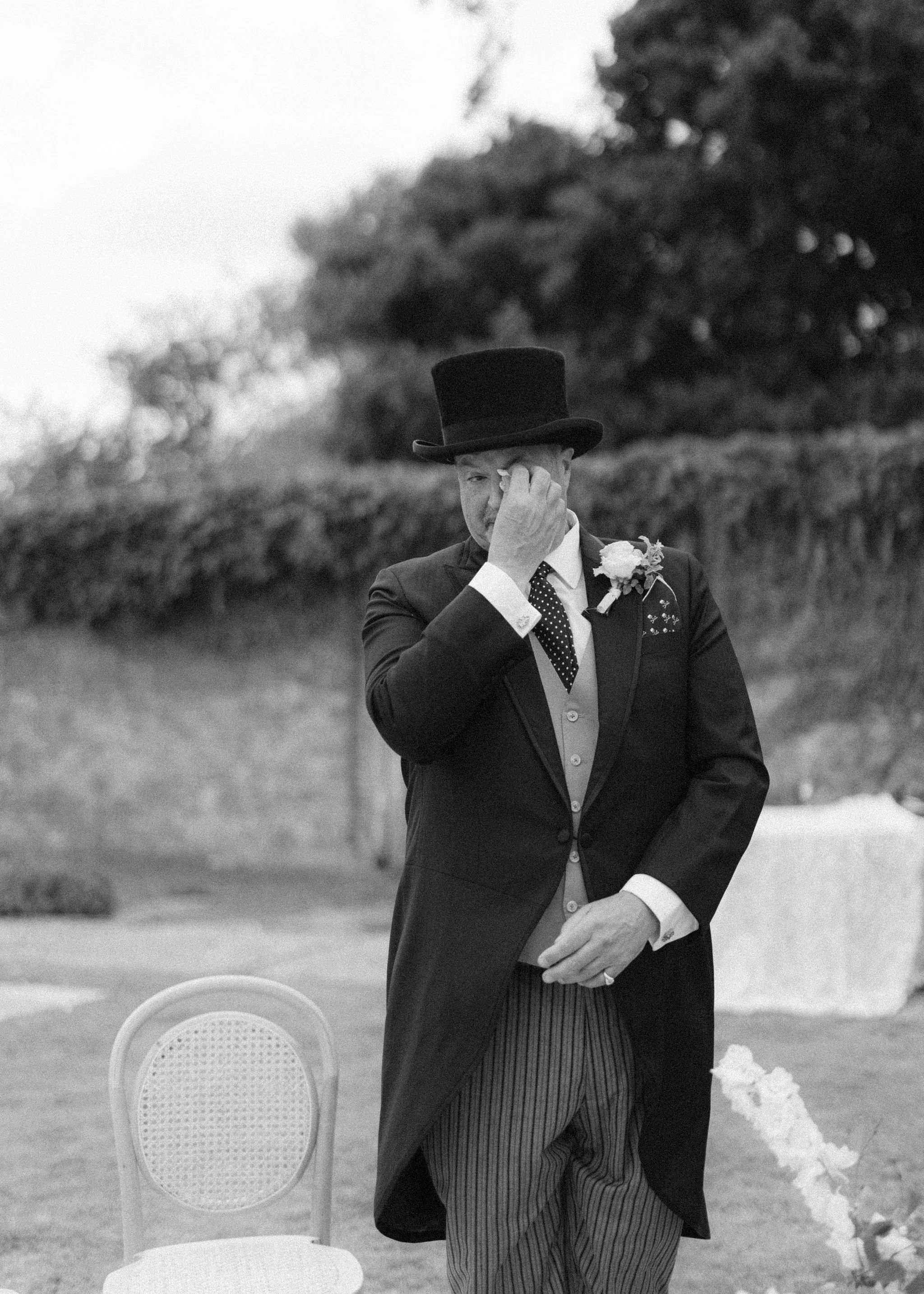 sail-and-peg-sussex-marquee-wedding-groom-tearing-up-top-hat.jpg