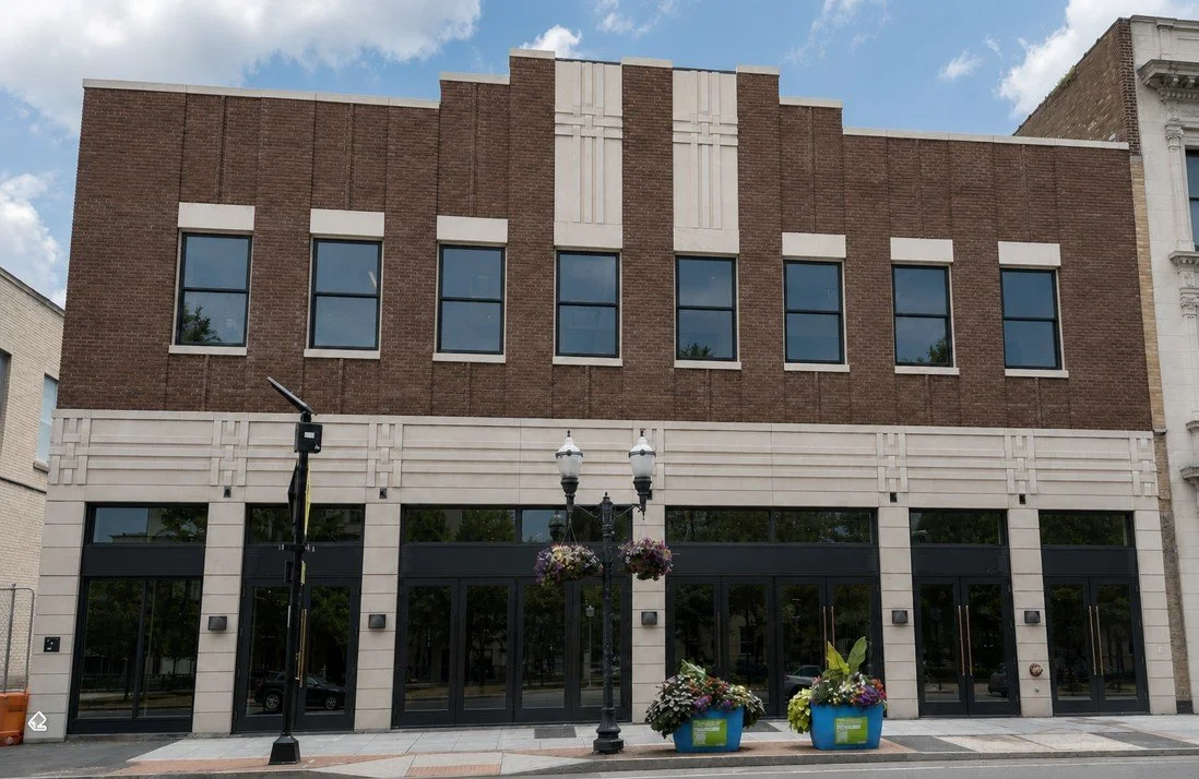 Custom interwoven geometric relief panels crown the adaptive reuse of Stamford's historic Advocate Building. A 2026 Cast Stone Excellence Awards entry.
