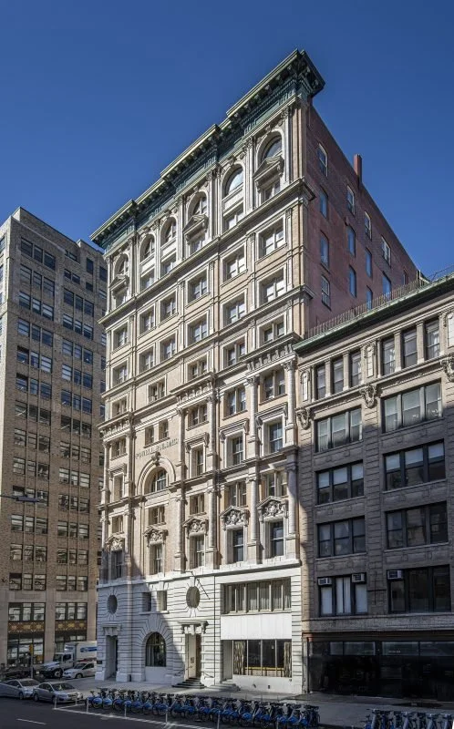 Cast stone replicated the terra cotta classical motifs and scrollwork of this Renaissance Revival landmark at 105 Hudson Street. A 2026 Cast Stone Excellence Awards entry.
