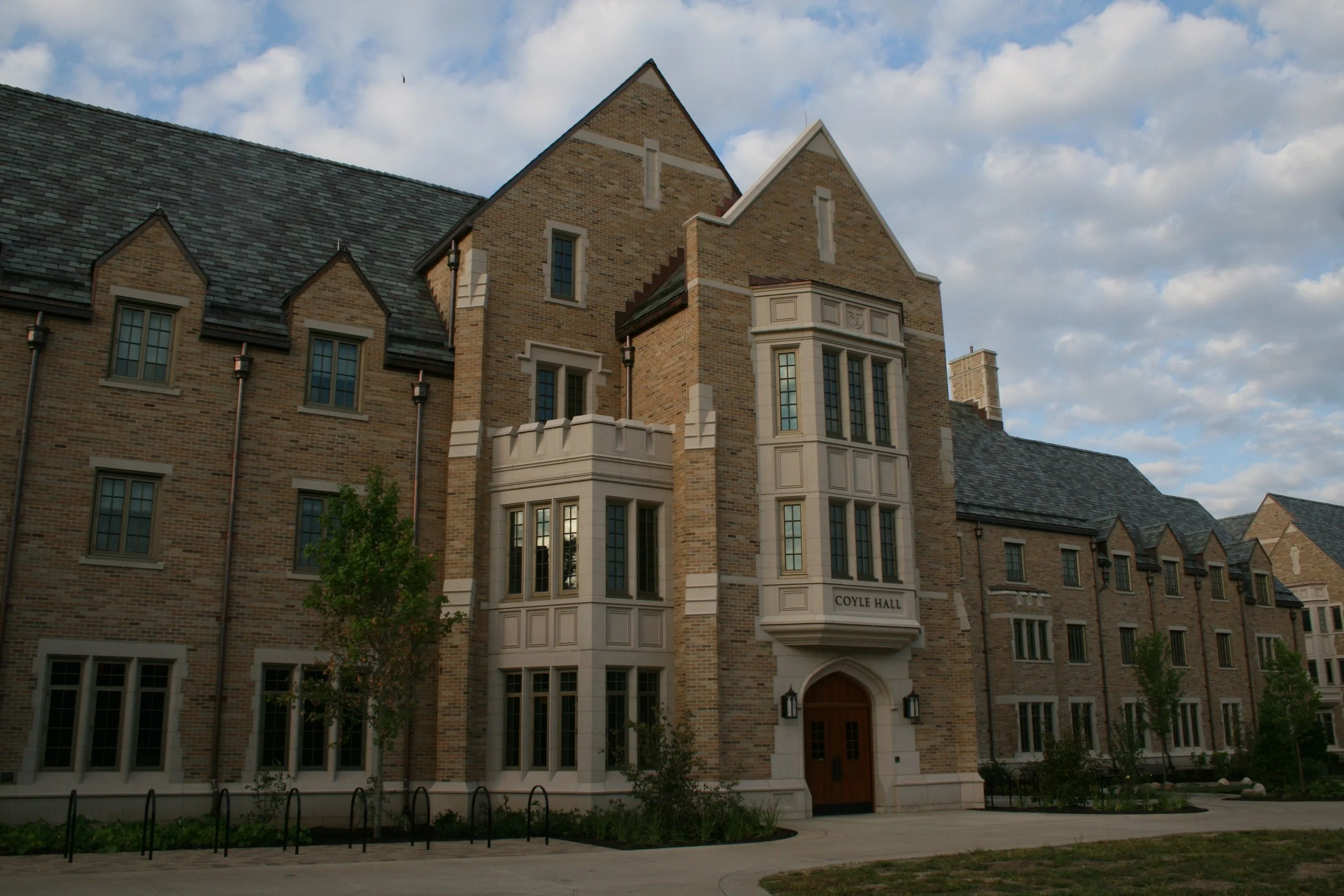 Cast stone base, banding, window surrounds, and entryways at Notre Dame's South Quad men's residence hall. A 2026 Cast Stone Excellence Awards entry.
