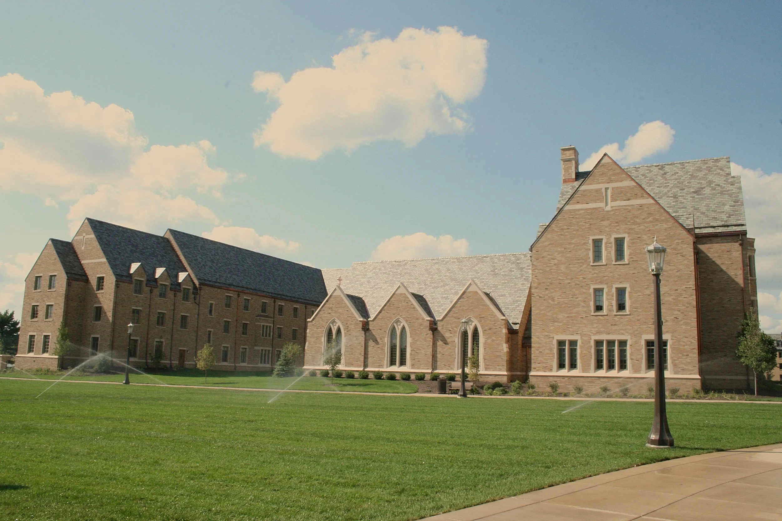 Cast stone banding, window surrounds, coping, and entryways at Notre Dame's South Quad women's residence hall. A 2026 Cast Stone Excellence Awards entry.