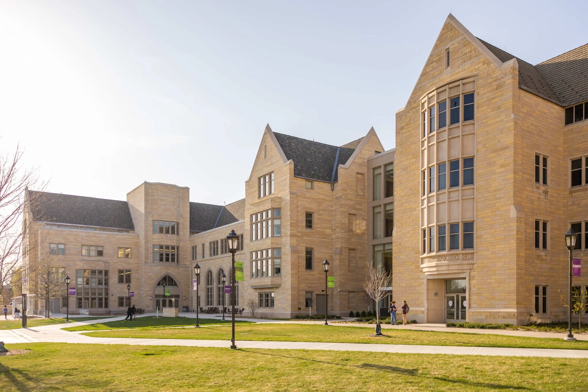 Cast stone base panels, bay windows, entries, and gable coping at the University of St. Thomas Schoenecker Center. A 2026 Cast Stone Excellence Awards entry.