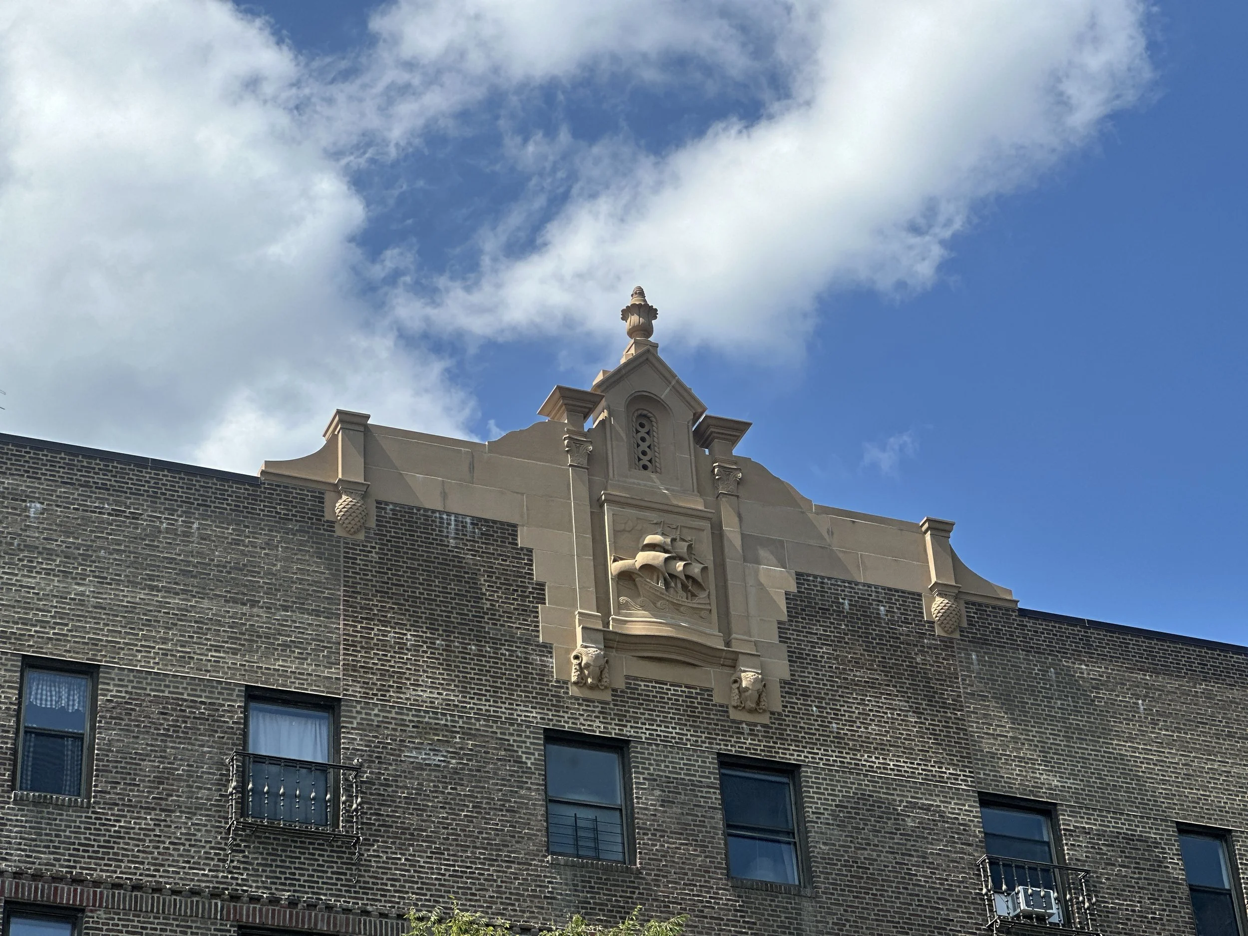 Cast stone reproduced the sail ship panels, pineapple stones, and arch window bases of this 1929 Sleepy Hollow complex. A 2026 Cast Stone Excellence Awards entry.