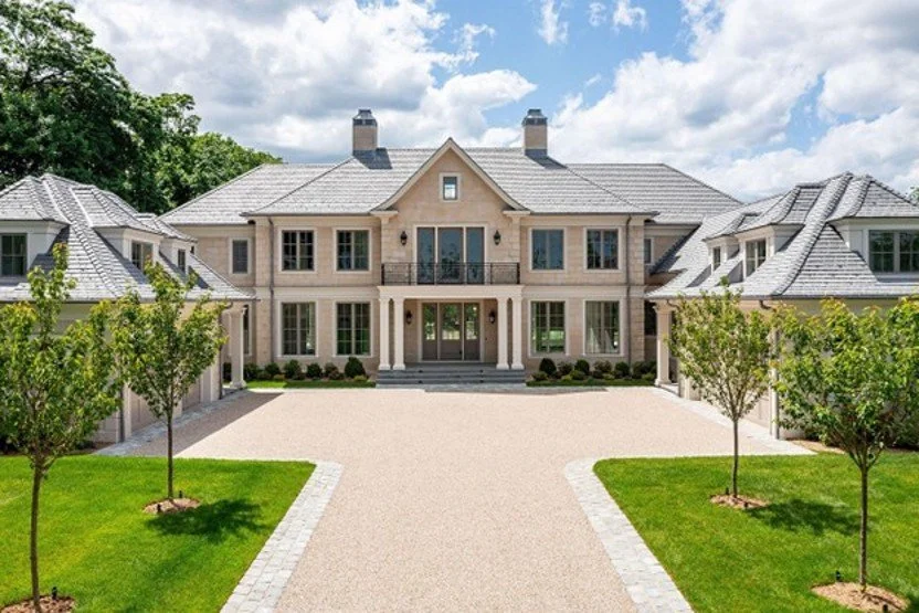 Window surrounds, columns, cornices, and rusticated corners earned this Darien, Connecticut home its name. A 2026 Cast Stone Excellence Awards entry.