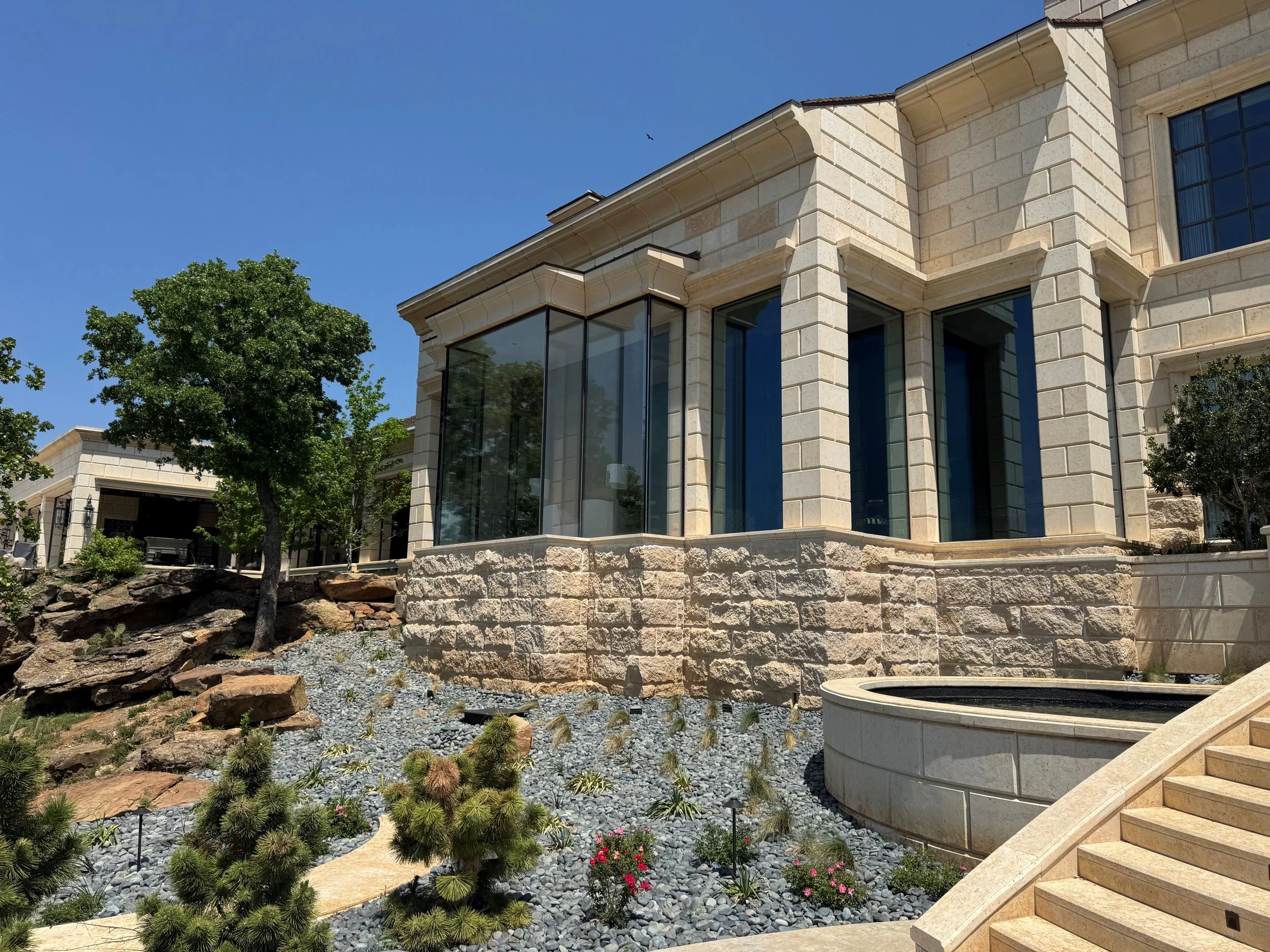 Cast stone matched, replaced, and extended the existing railing, pier caps, and planters at a private residence. A 2026 Cast Stone Excellence Awards entry.