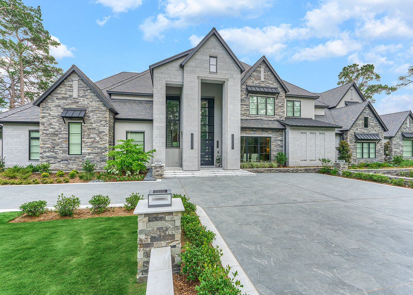 Cast stone headers, sills, and variegated veneer unify an 11,865 square foot Texas residence. A 2026 Cast Stone Excellence Awards entry
