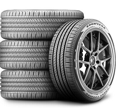 Stack of Goodyear tires and a tire with a wheel rim, showcasing tire tread pattern.