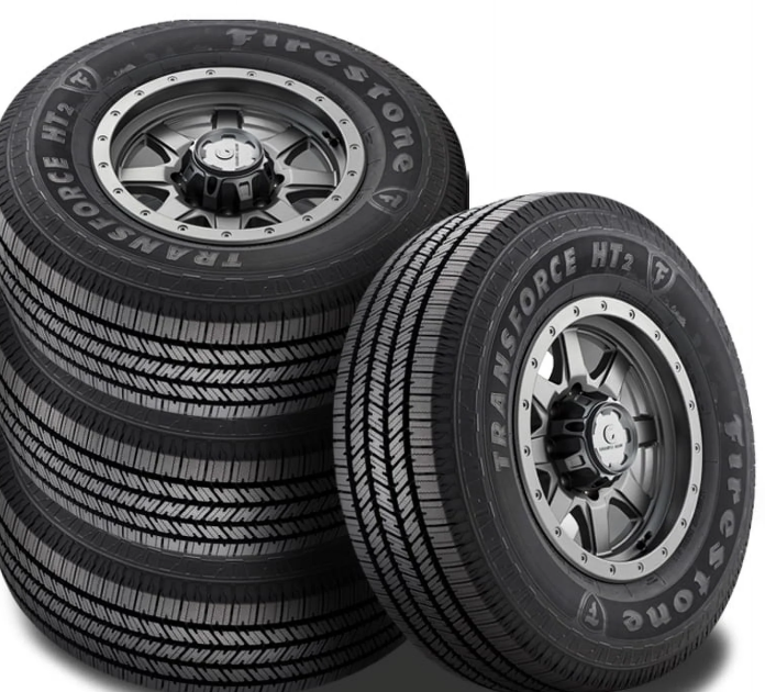 Stack of Firestone Transforce HT2 tires with tread pattern visible