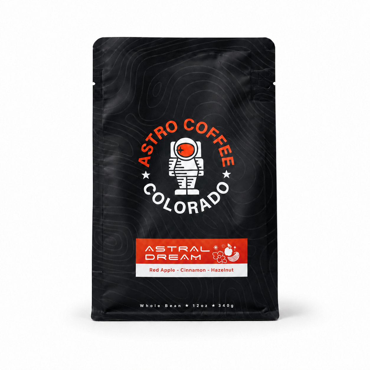 Black coffee bag with a logo of an astronaut and the text 'Astro Coffee Colorado', and a label reading 'Astral Dream' with flavor description 'Red Apple - Cinnamon - Hazelnut'.