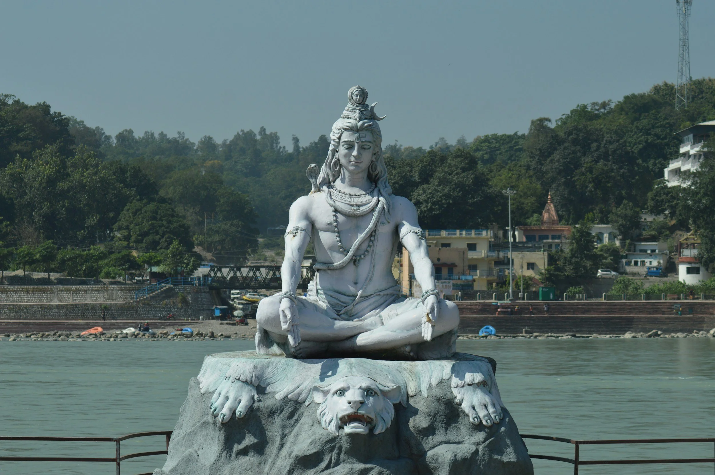 A statue of Lord Shiva seated in meditation beside the Ganges in Rishikesh.