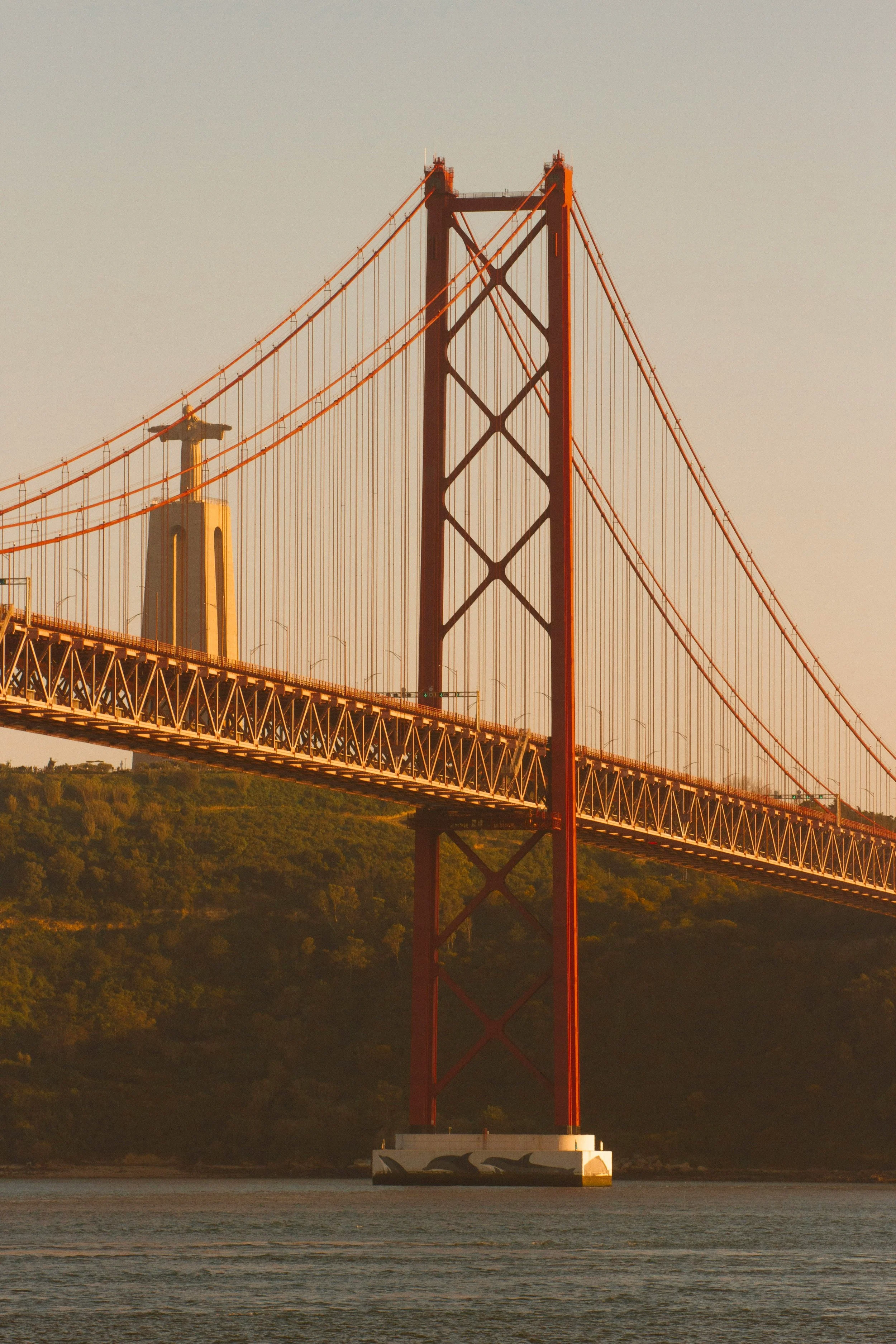 The 25 de Abril Bridge over the Tagus River in Lisbon at sunset