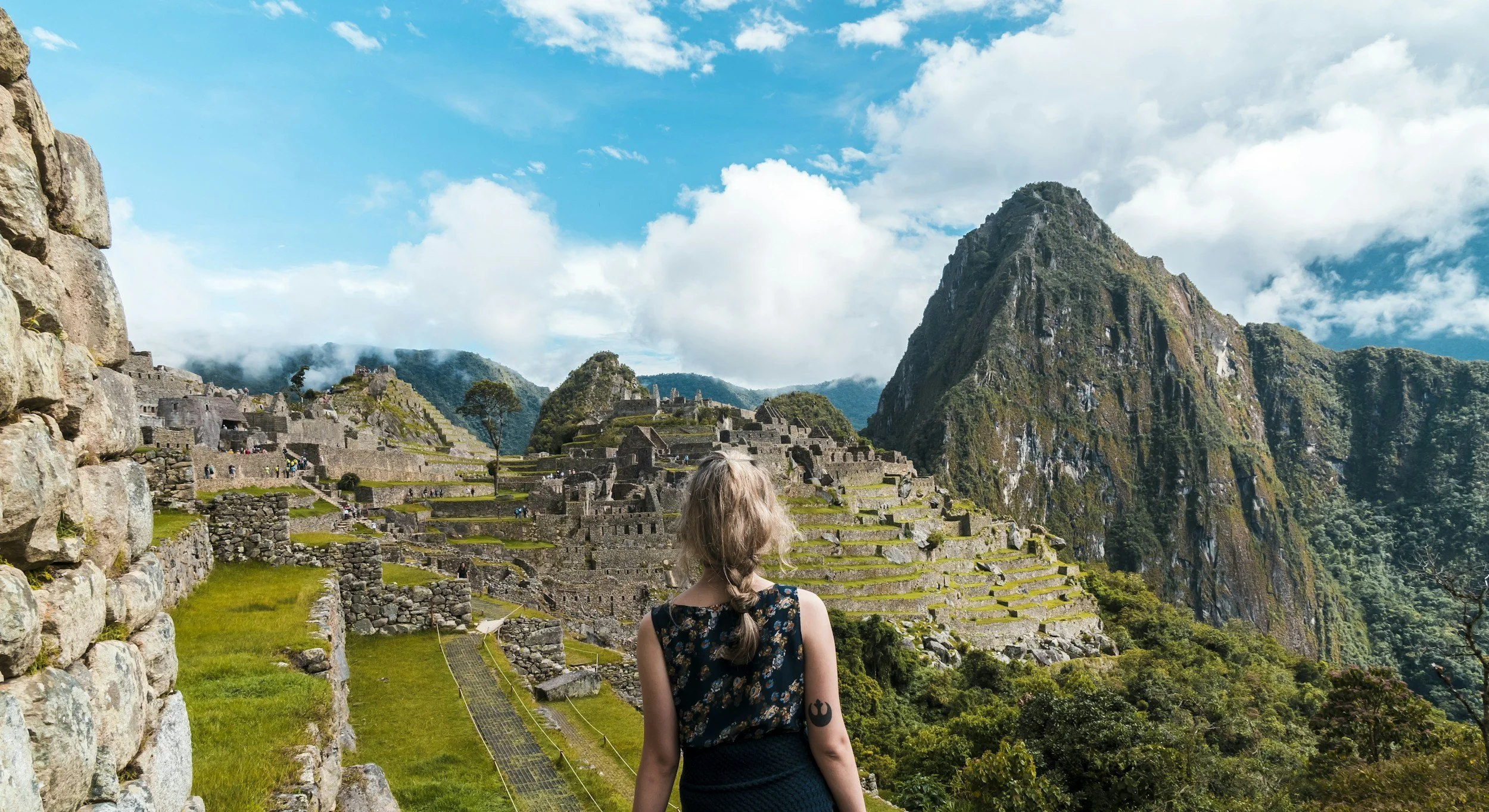 Woman traveler looking out over Machu Picchu, Peru