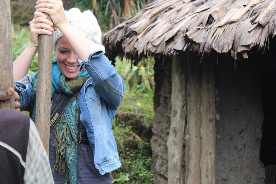 A villager outside a thatched-roof hut in rural Tanzania.