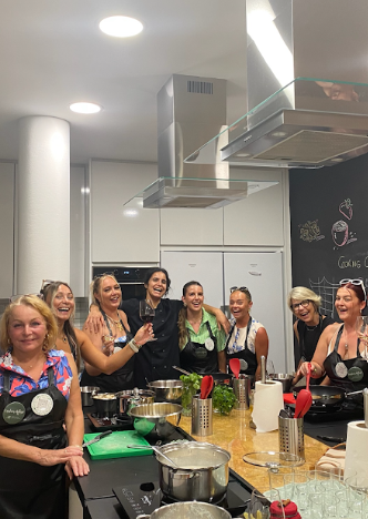 Group of women smiling together during a cooking class in Lisbon