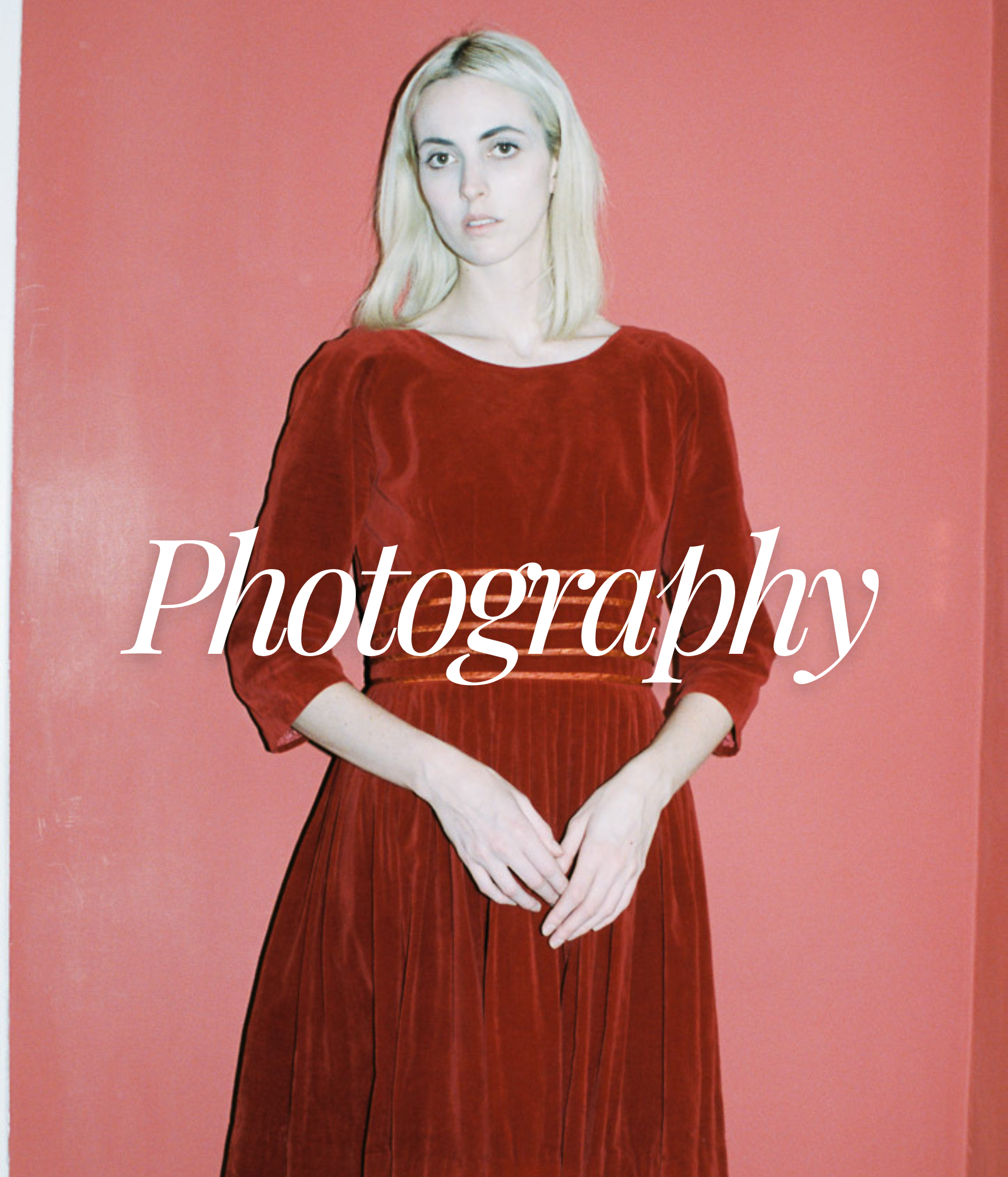 A woman with blonde hair wearing a red velvet dress standing against a pink background, with the word 'Photography' overlayed on the image.