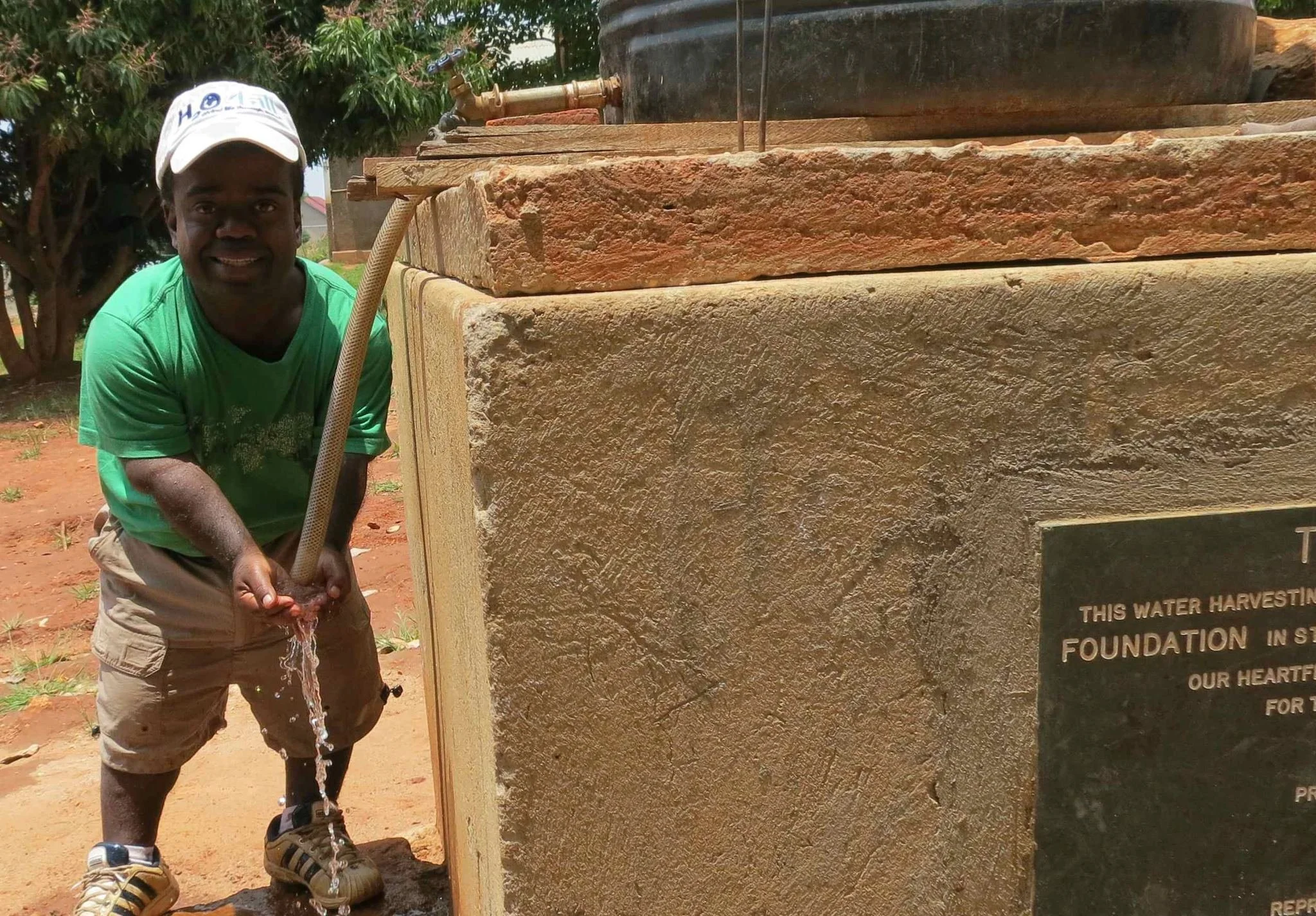 Tim Muttoo in Uganda with water