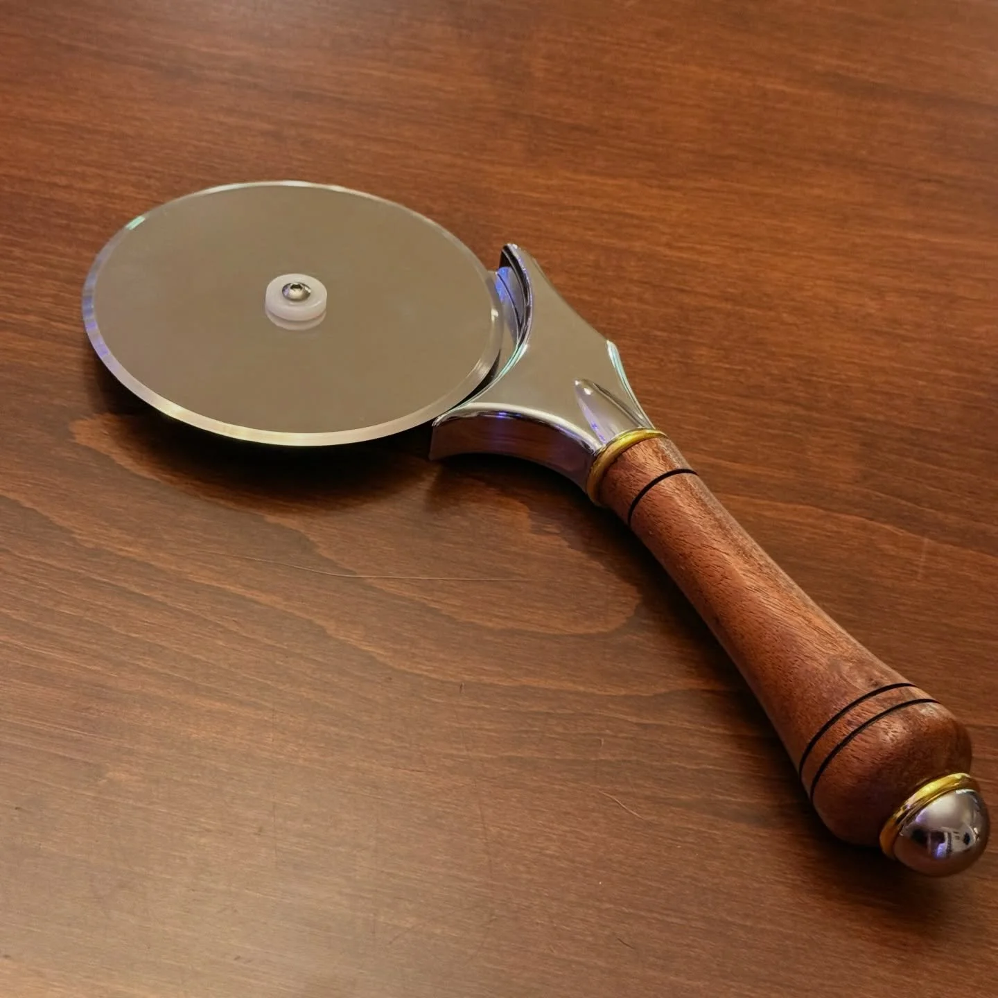 Mahogany handle for a deluxe pizza cutter

#michielssignature #handcrafted #lathe #woodturning