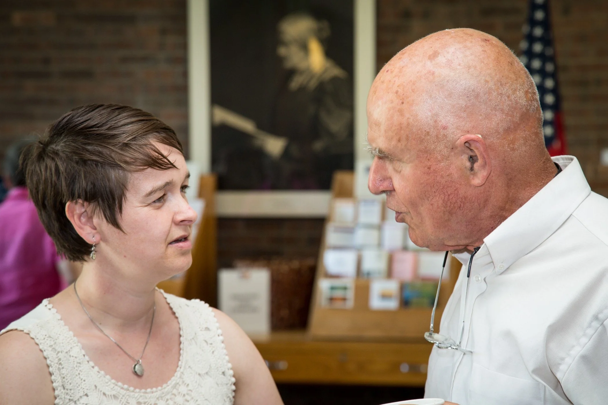 An older person speaking with a younger person