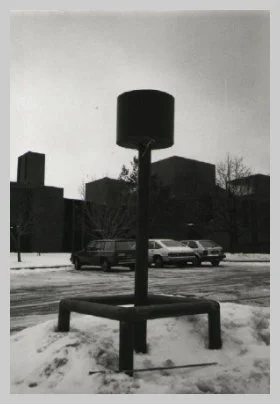 a photo of the old light posts featuring a rounded top and a stocky square bottom