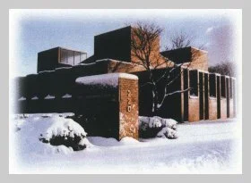 a photo of the completed building covered in snow