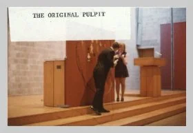 a photo taken of the chancel featuring the original pulpit. a caption reads "the original pulpit"