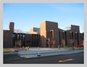 a photo showing the exterior, "front" of the building taken from the parking lot