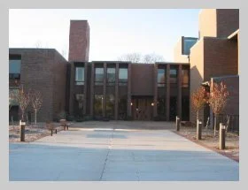 an exterior photo of the church courtyard and main entrance door.