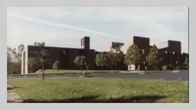 a photo of the exterior of the building, taken from the parking lot