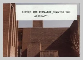 a photo of the back of the building, taken before the elevator was installed in the 1960's. a caption reads "Before the elevator, showing the airshaft"