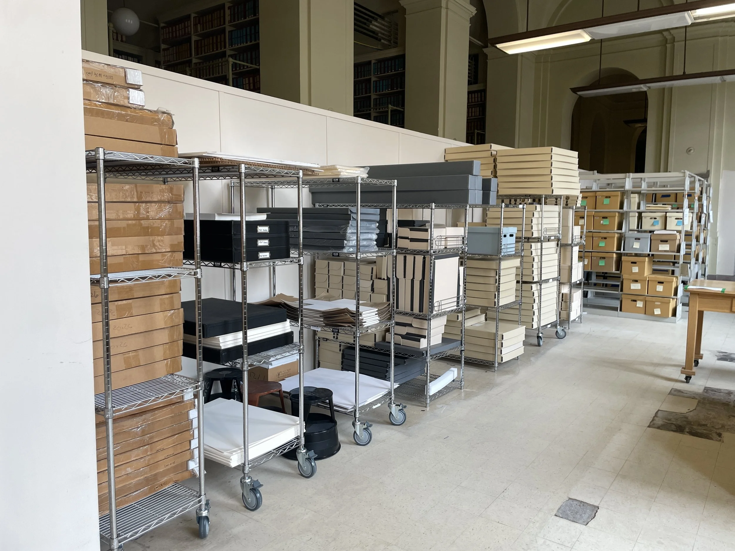 Shelves filled with boxes and materials inside a library or archive.