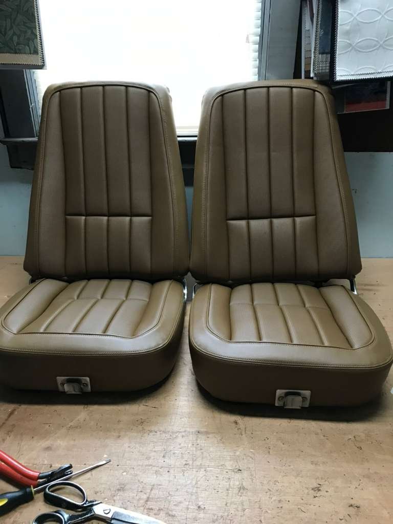 Restored tan leather car seats after professional upholstery work in Connecticut workshop