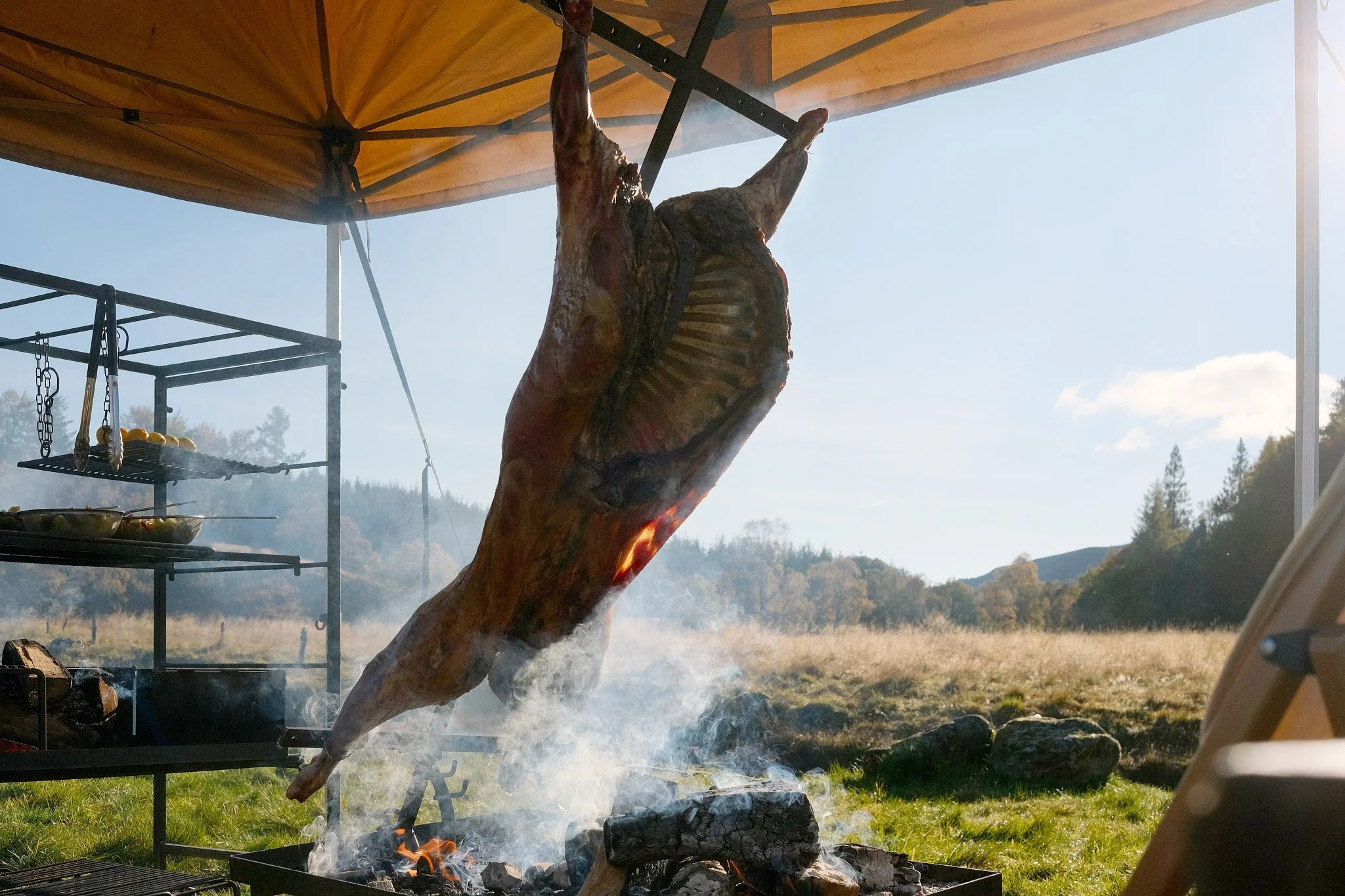 Asado Lamb on a Asado Cross over a fire pit for a banquet feast