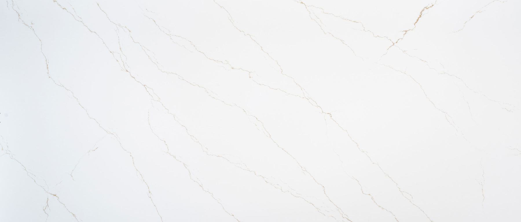 Close-up view of a white marble surface with light brown veining.
