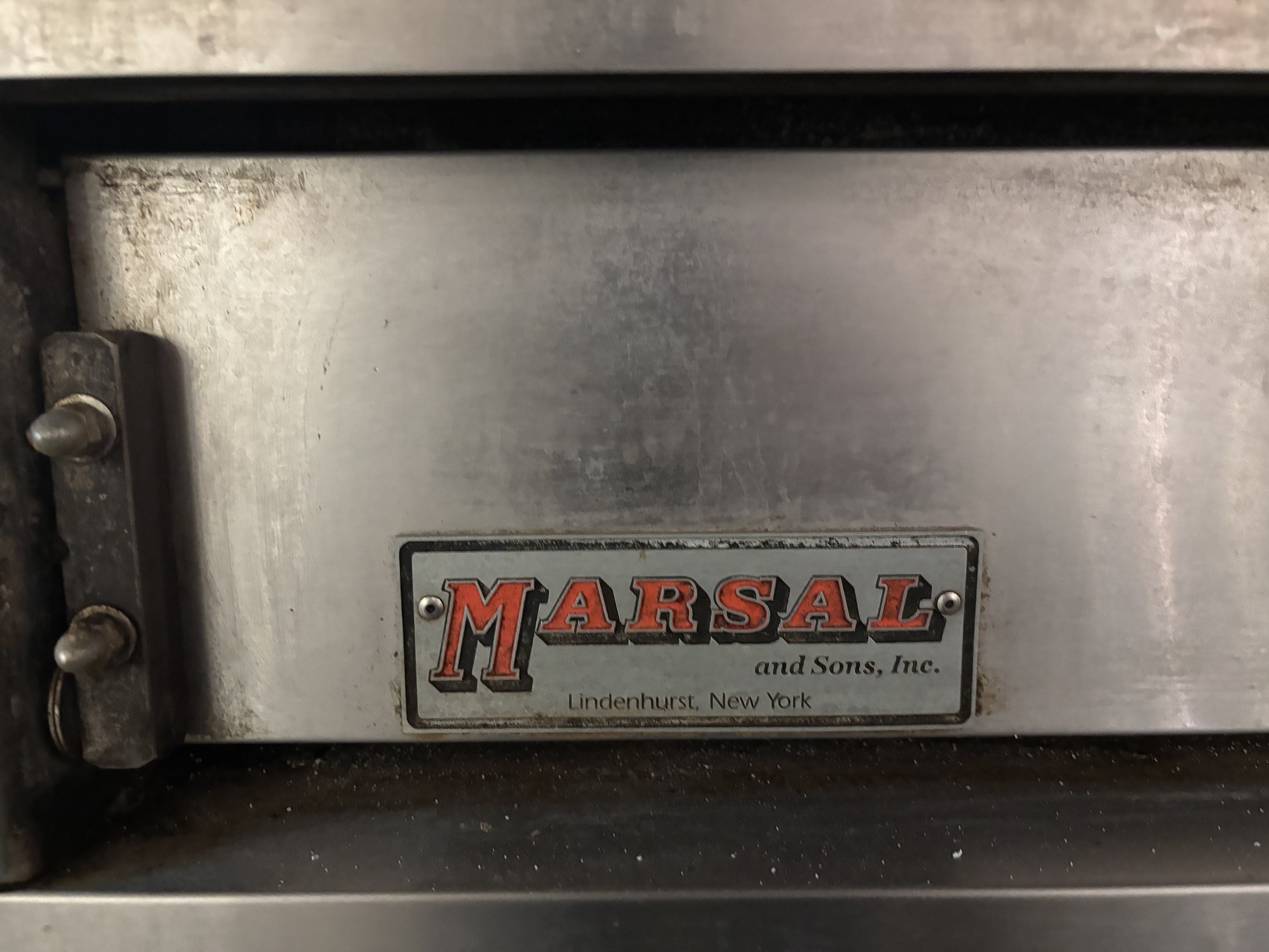 Close-up of a Marsal pizza oven door with company logo